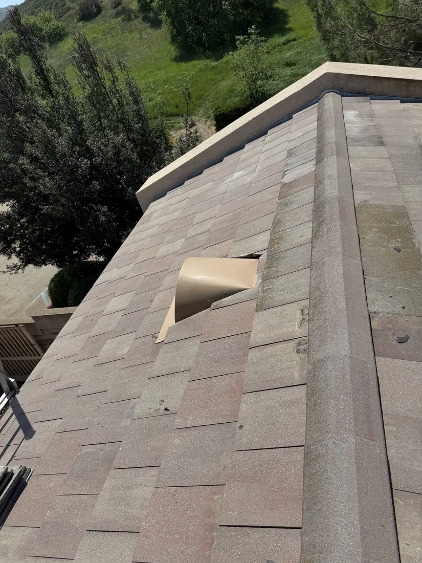 Shingle lifted off the underlayment near a rake edge on a repair call.
